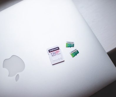 white macbook on brown wooden table macbook battery health settings, battery preferences, macos ui