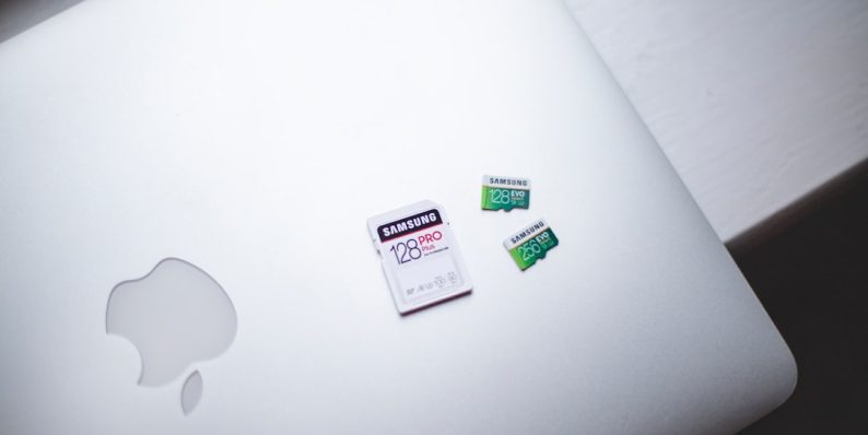 white macbook on brown wooden table macbook battery health settings, battery preferences, macos ui
