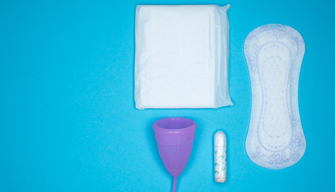 a blue table with a toothbrush, a tube of toothpaste and a sanitary pads packaging, menstrual hygiene, feminine care a blue table with a toothbrush, a tube of toothpaste and a sanitary pads packaging, menstrual hygiene, feminine care