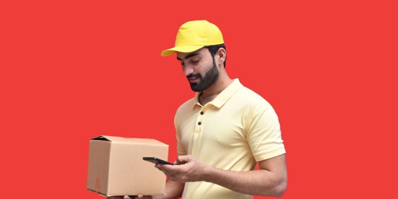 a man in a yellow hard hat holding a phone inventory restock, cancelled order notification, ecommerce workflow
