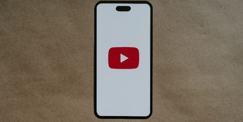 a white phone with a red youtube logo on it youtube full screen, user can’t scroll, youtube ui bug