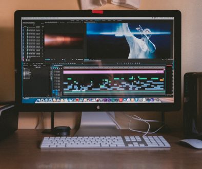 black Apple iMac besides white Apple Magic mouse and keyboard premiere pro, media cache, software settings