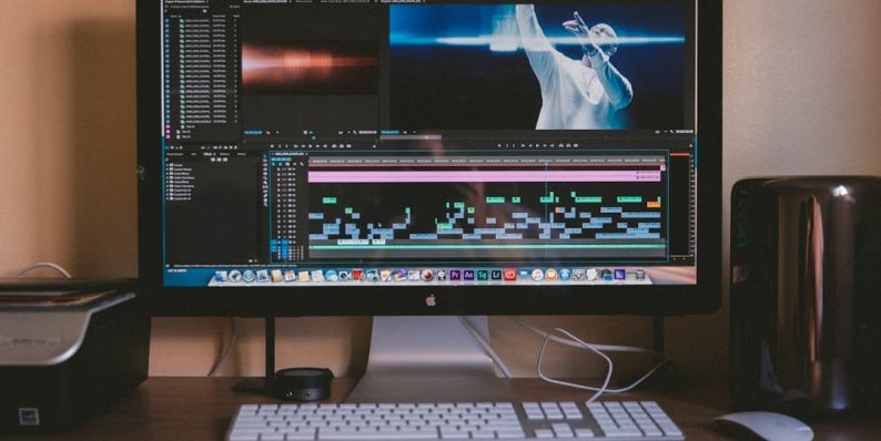 black Apple iMac besides white Apple Magic mouse and keyboard premiere pro, media cache, software settings