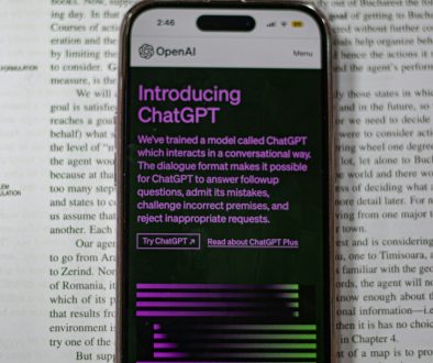 a cell phone sitting on top of an open book chatgpt interface branching conversations example