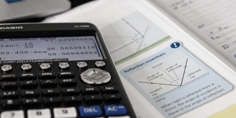 a close up of electronics math formulas, academic books, financial systems