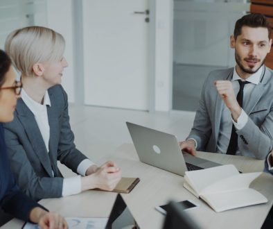 Four professionals in a business meeting around a table. communication teamwork office presentation