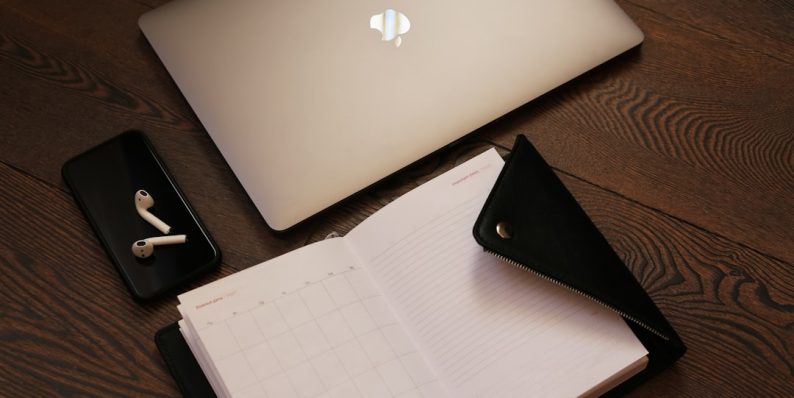 silver macbook beside black iphone 5 business branding kit laptop logo samples