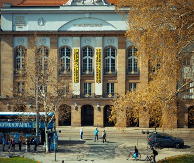 A gorgeous building with people walking around. university lecture, academic conference, politics