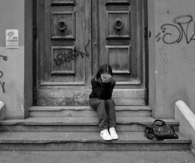 a person sitting on steps outside a building unemployment, school child, financial stress, family home a person sitting on steps outside a building unemployment, school child, financial stress, family home