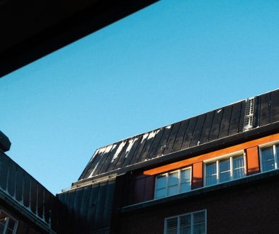 a tall building with windows and a sky background solar panels business rooftop energy savings