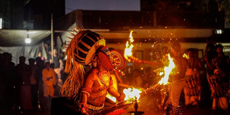 A traditional indian dance performance with fire and lights. onnilaina ritual crowds, cultural festival, sacred fire