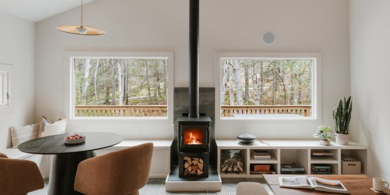 Cozy living room with fireplace and large windows. modern storage, minimalist interior, living room decor