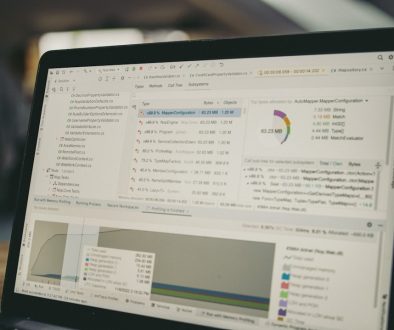 Laptop screen displaying code and data charts. team laptop documents cloud