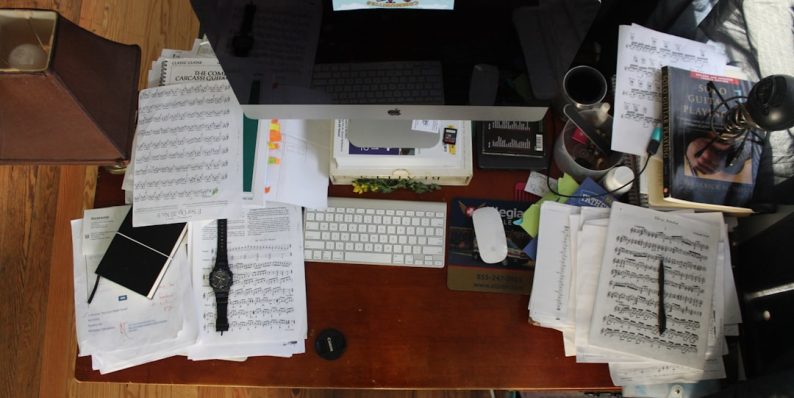 silver iMac with Magic Mouse and Keyboard people organizing files computer teamwork paperless