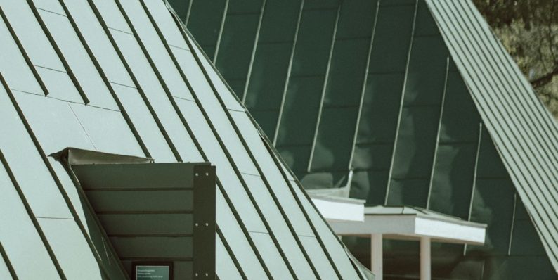 a group of tables and chairs outside of a building natural slate roof,synthetic roofing,aesthetic house design