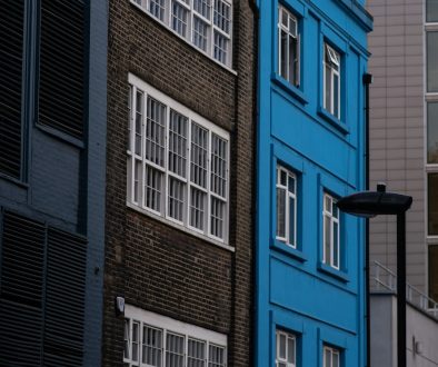 Buildings with varied colors and symmetrical windows. London skyline, Thames river, historic architecture