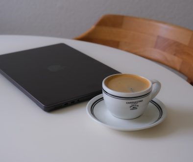 Laptop and coffee cup on a white table creative workspace laptop coffee email interface
